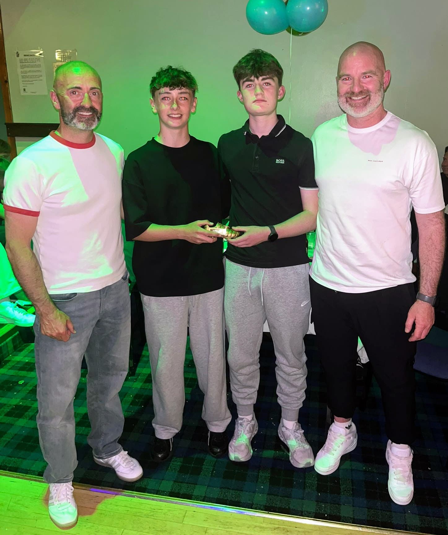Two young award recipients standing with Spartinios coaches