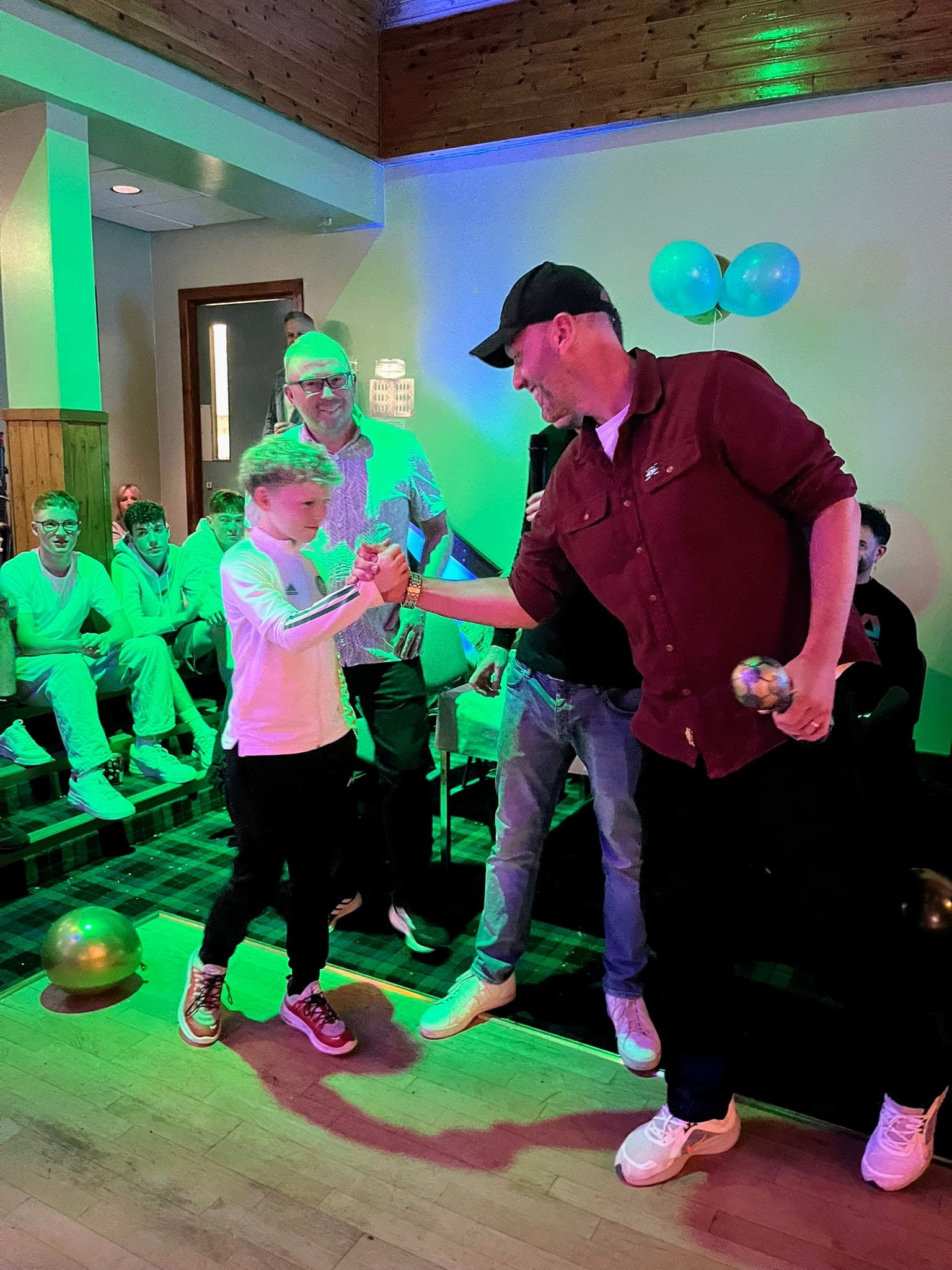 A young player greeting a coach during the awards presentation