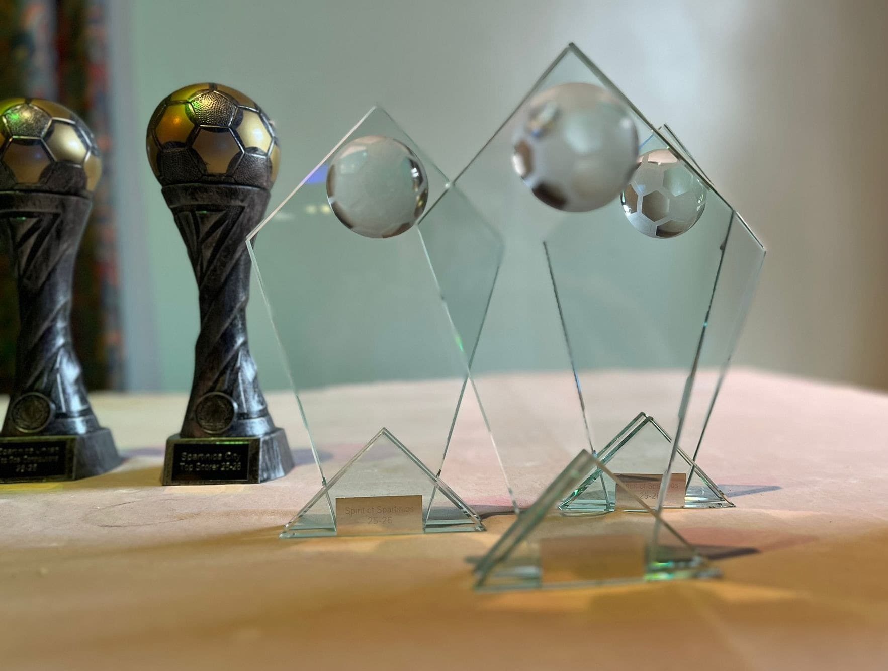 Glass and football trophies arranged for the Spartinios awards night